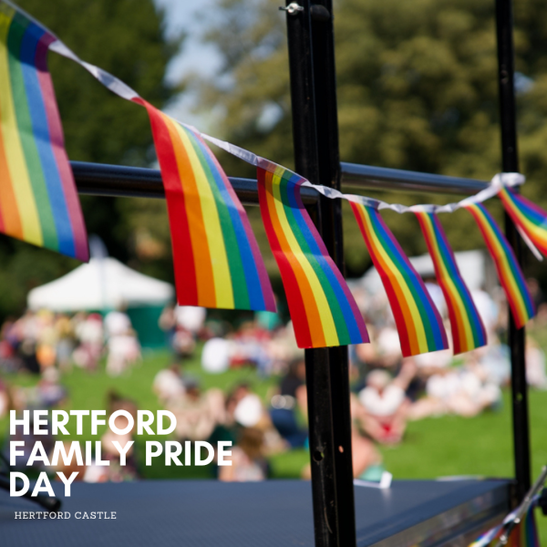 Pride flags draped on a stage with event name and event details